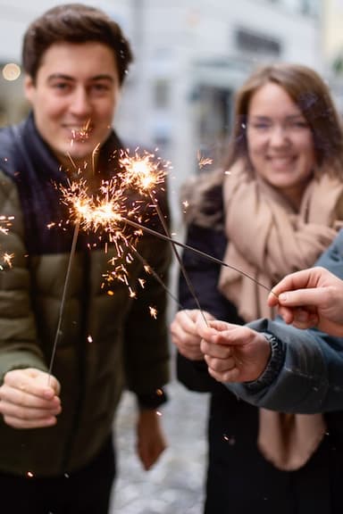 aclipp team holding sparklers at a team event.